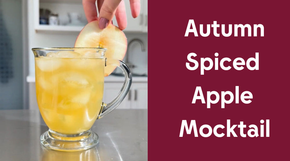 a glass sits on a table with a turmeric tonic mocktail inside