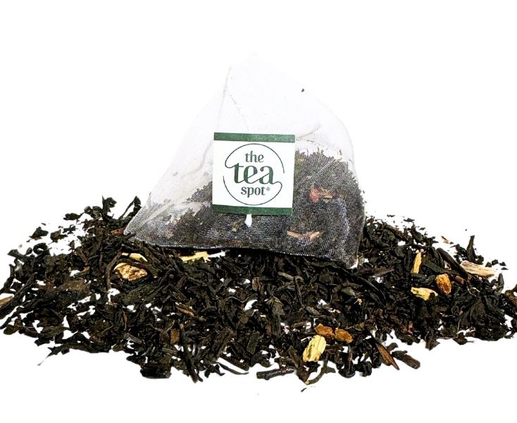 
                  
                    a tea bag sits atop a pile of loose leaf black tea
                  
                