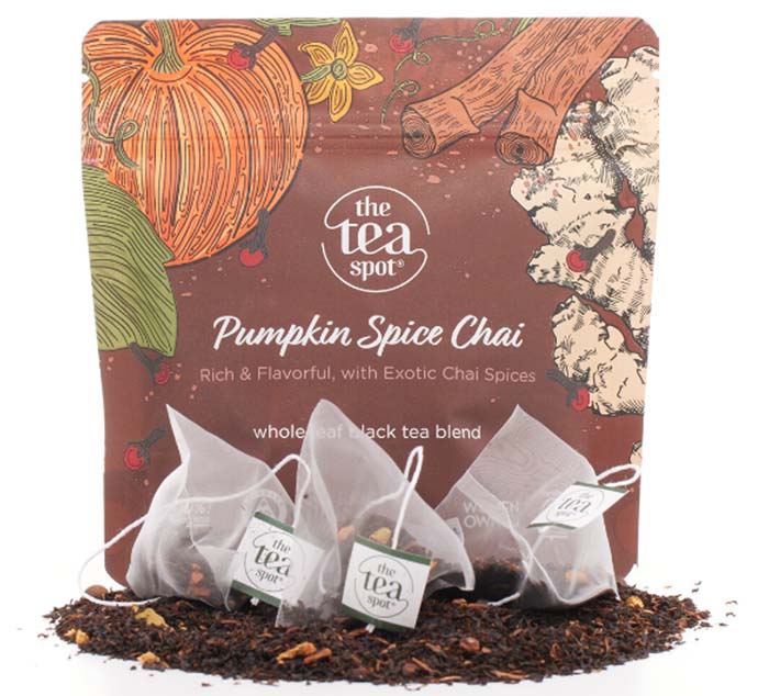 a bag labeled pumpkin spice chai sits behind tea bags and loose leaf tea