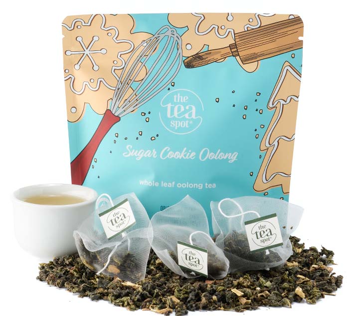 Sugar Cookie Oolong tea packaging with loose leaf tea, a teacup, and tea bags, featuring festive baking illustrations