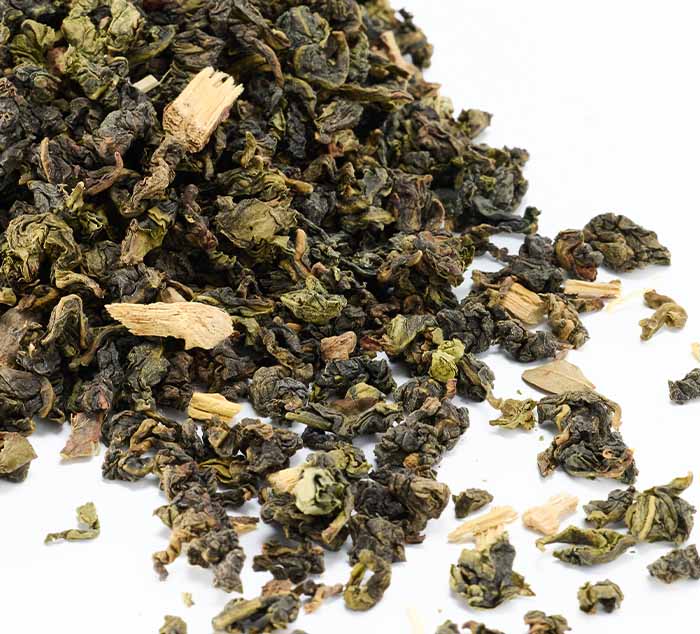 
                  
                    Close-up of loose Sugar Cookie Oolong tea leaves on a white background
                  
                