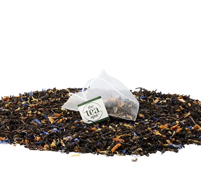 
                  
                    a tea bag of winter solstice tea sits atop a pile of winter solstice loose leaf tea
                  
                